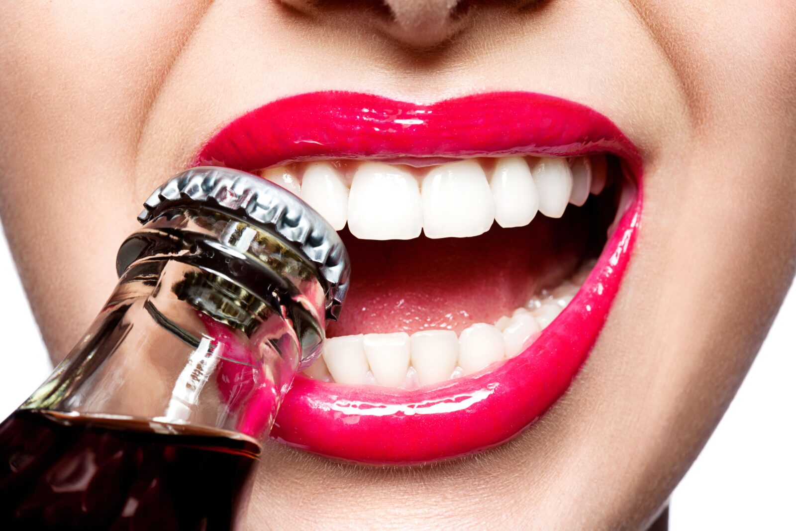 woman using teeth to open bottle
